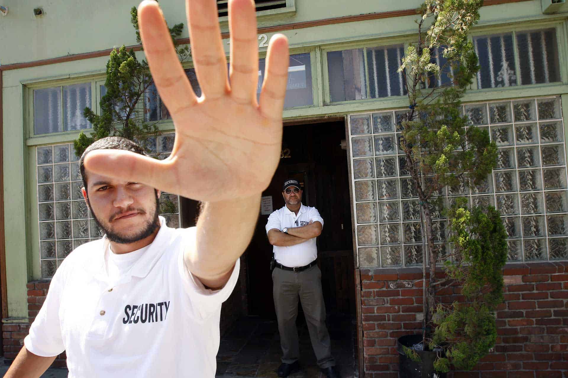 <p>A security guard working for the Van Nuys Organics medical marijuana dispensary puts his hand in front of the camera as the photographer takes a picture of the dispensary storefront from the public sidewalk in the Eagle Rock section of Los Angeles, California. (Photo by David McNew/Getty Images)</p>
