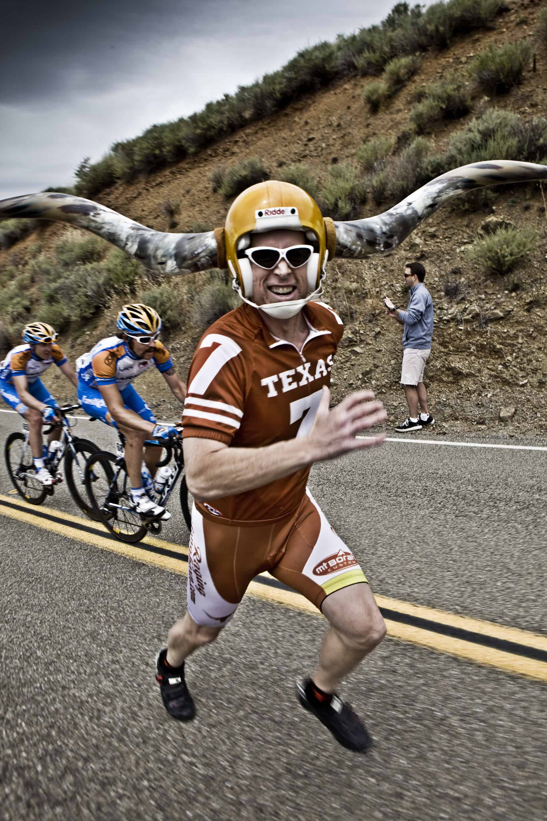 <p>I think this guy went to Texas! But he was everywhere. Somehow he would make it everyday to each stage. Roads are shut down hours before the entire race passes through. His helmet looked like it took out a couple of the riders in the past.</p>
